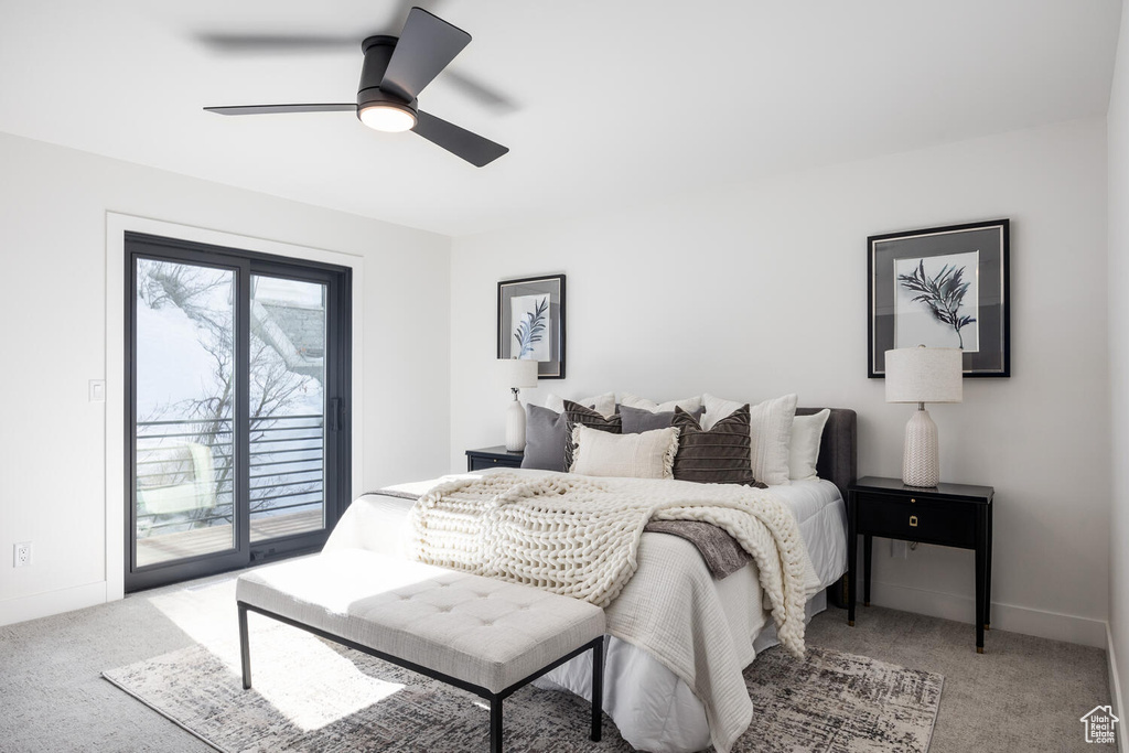 Carpeted bedroom with ceiling fan and access to exterior