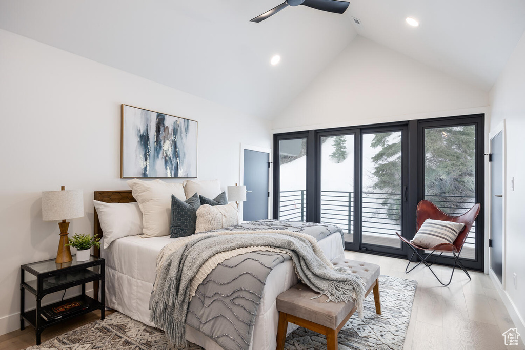 Bedroom with high vaulted ceiling, ceiling fan, hardwood / wood-style floors, and access to exterior