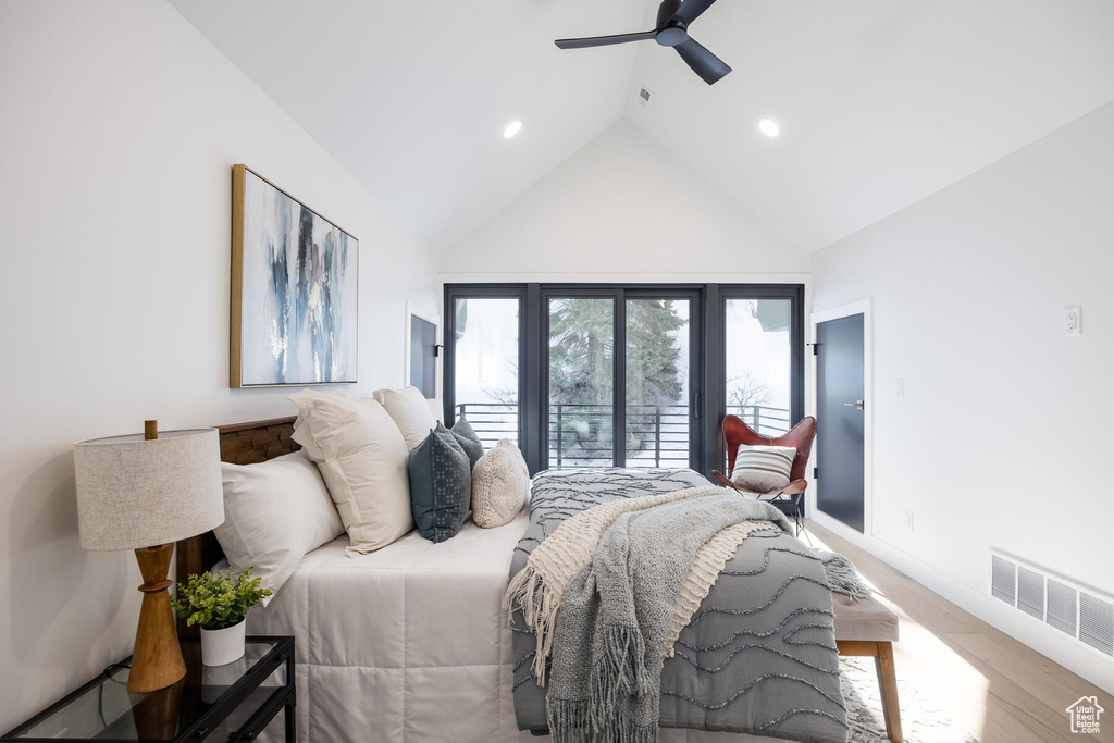 Bedroom featuring light hardwood / wood-style flooring, high vaulted ceiling, and ceiling fan