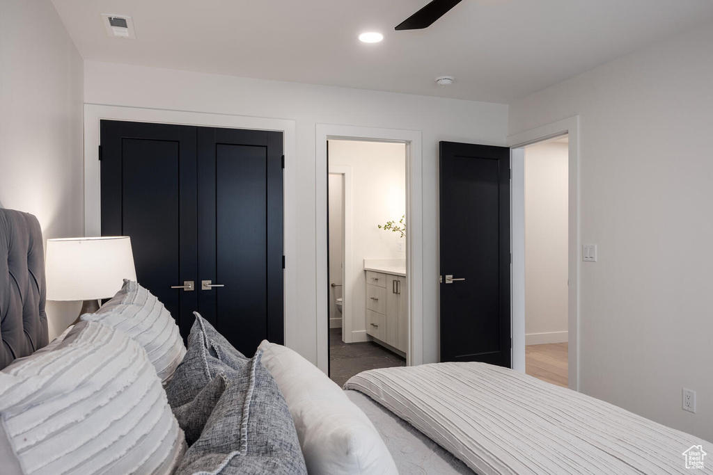 Bedroom with ceiling fan, a closet, hardwood / wood-style floors, and ensuite bath