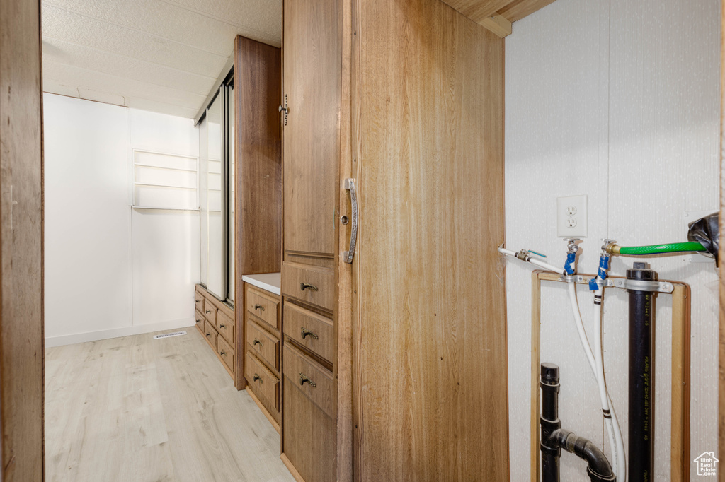 Bathroom featuring hardwood / wood-style flooring and a textured ceiling