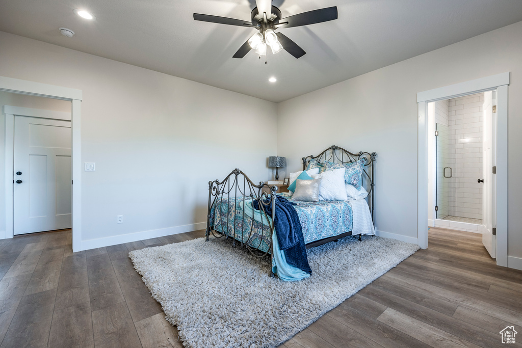 Bedroom featuring ensuite bath, ceiling fan, and dark hardwood / wood-style flooring