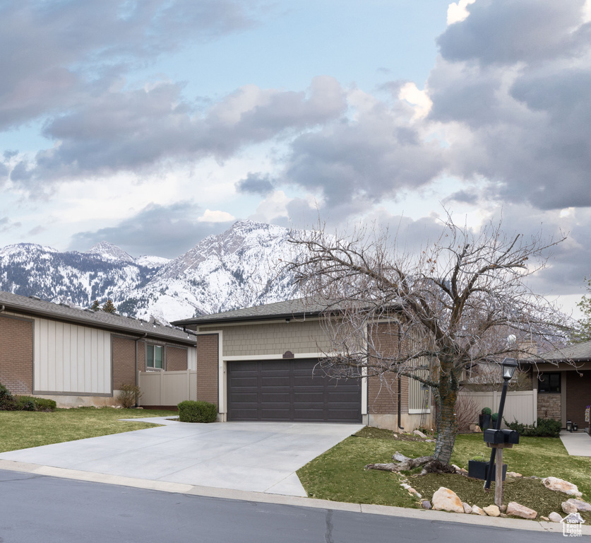 Ranch-style house with a mountain view and a garage