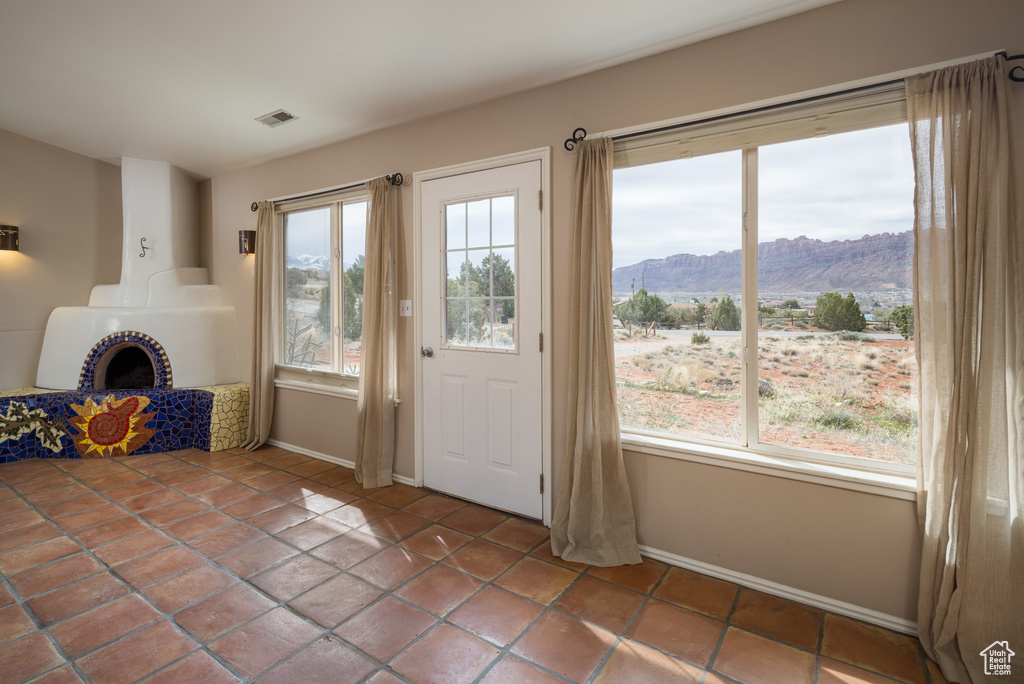 Doorway with a mountain view and dark tile flooring