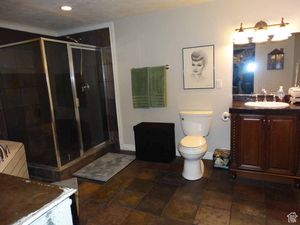 Bathroom with vanity, toilet, tile flooring, and a shower with shower door