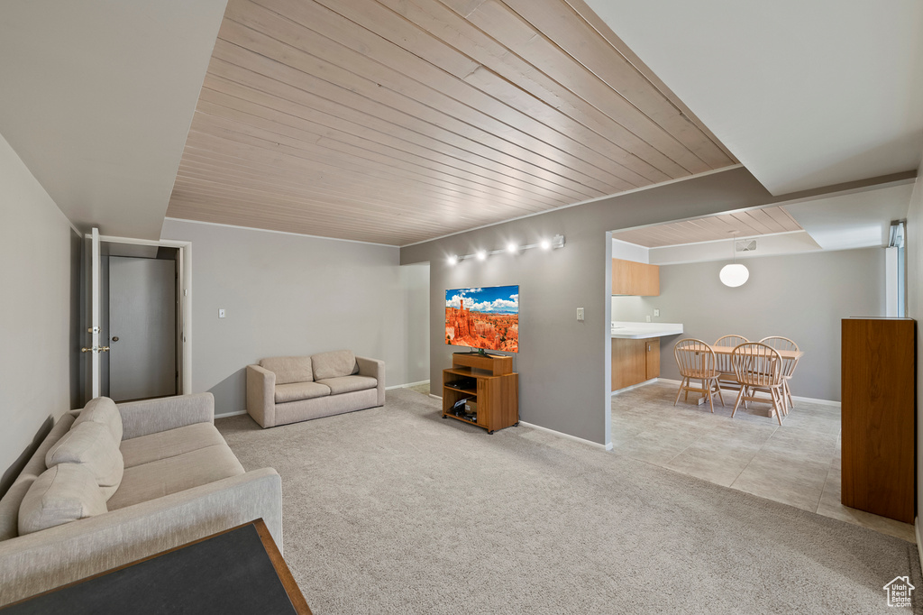 Living room featuring wooden ceiling and light tile floors