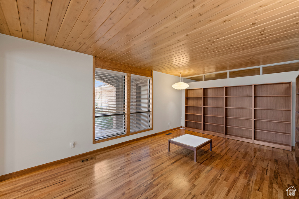Unfurnished room featuring light hardwood / wood-style flooring and wood ceiling