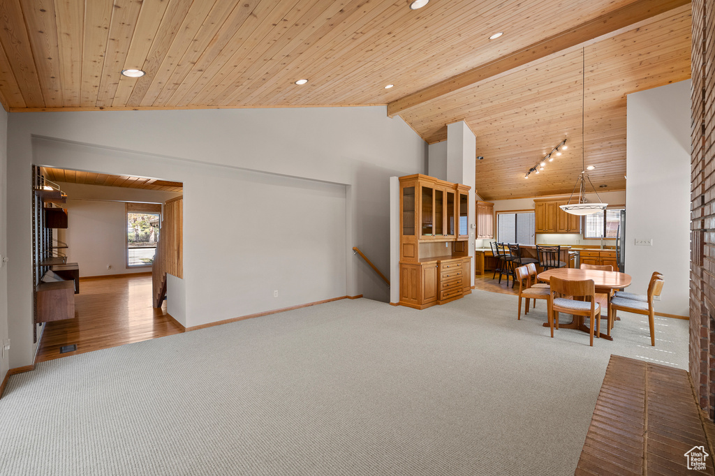 Living room featuring light carpet, beam ceiling, wooden ceiling, and high vaulted ceiling