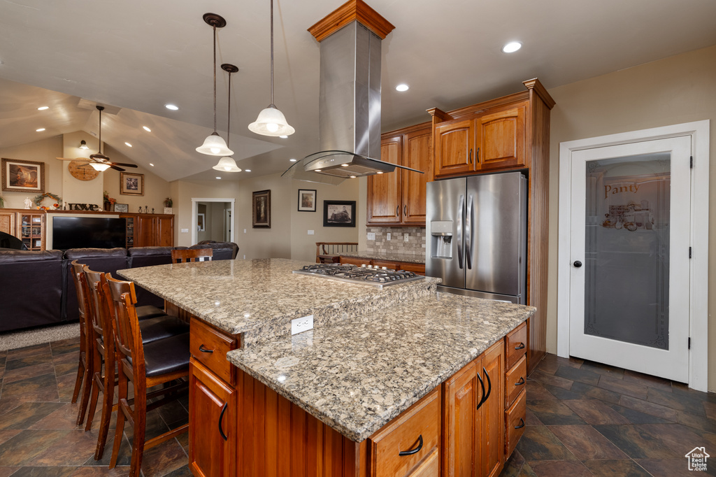 Kitchen with backsplash, ceiling fan, island range hood, a kitchen island, and appliances with stainless steel finishes