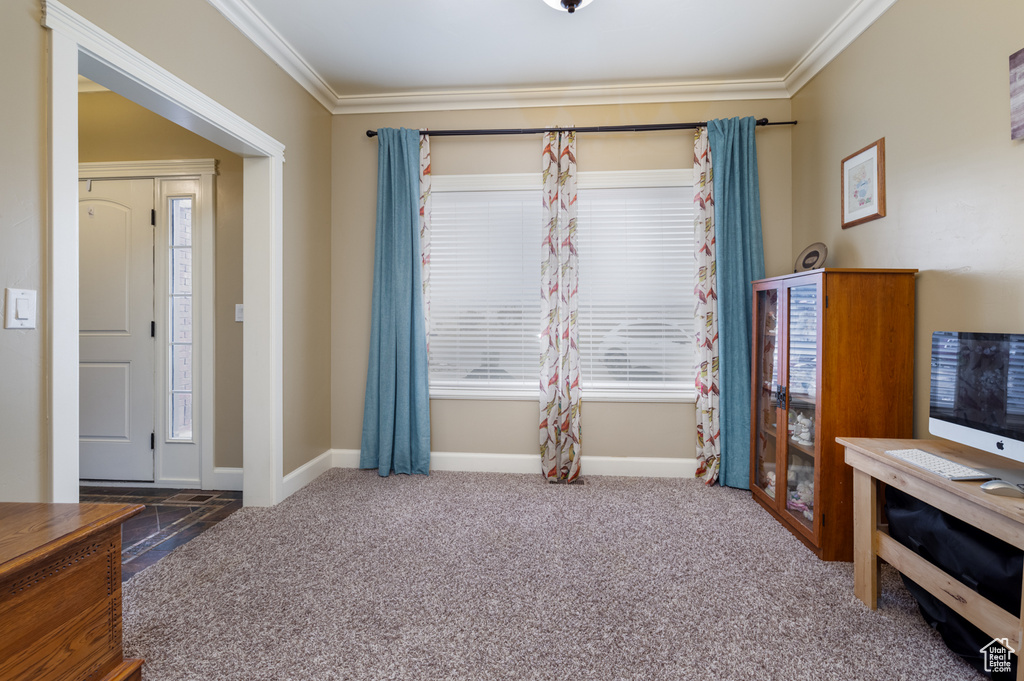 Interior space featuring dark carpet and crown molding