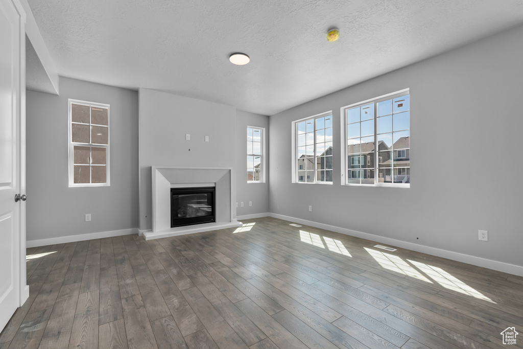 Unfurnished living room with dark hardwood / wood-style floors