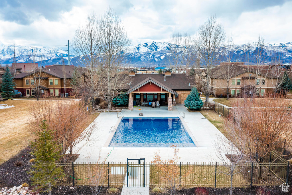 View of swimming pool with a patio area and a mountain view