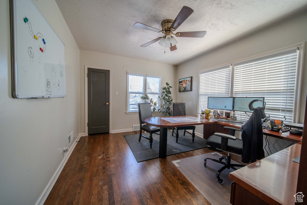 Office space featuring dark hardwood / wood-style floors and ceiling fan