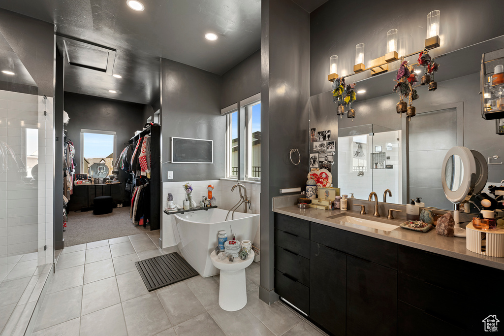 Bathroom with vanity, a bidet, a bath, and tile flooring