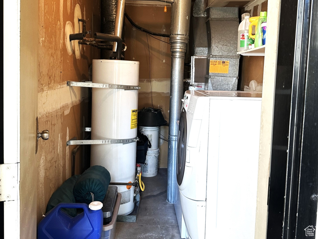 Utility room featuring washer / dryer and secured water heater