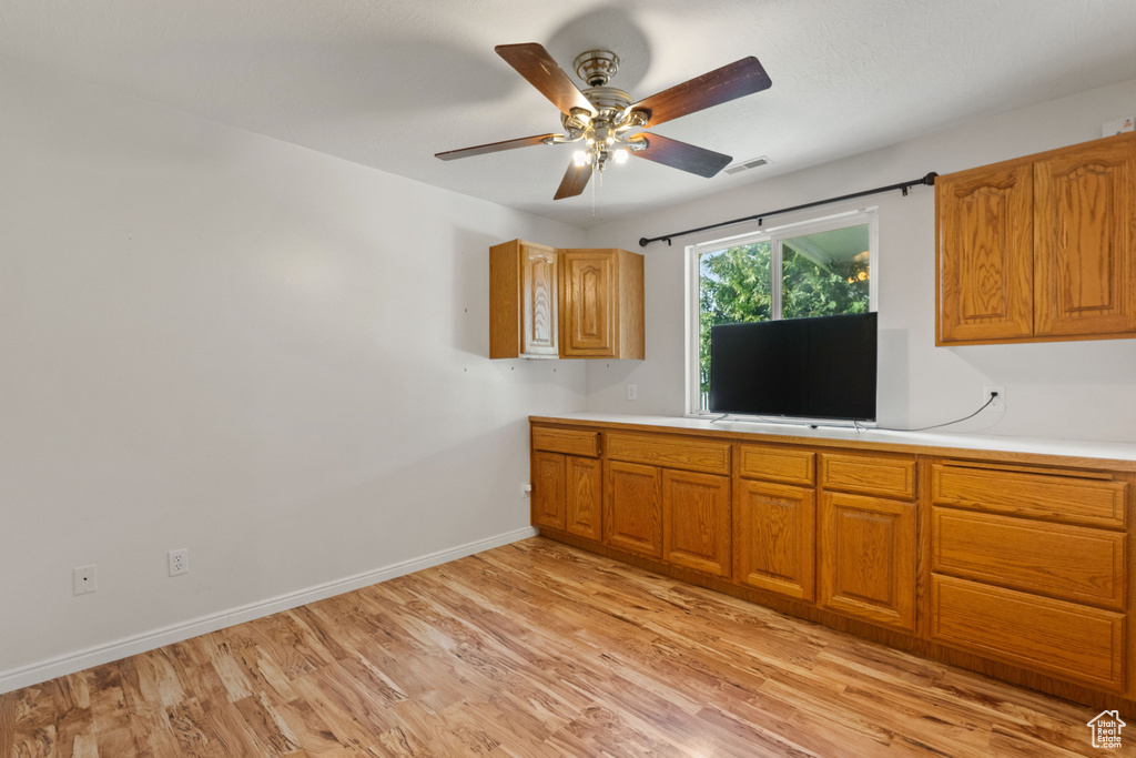 Kitchen featuring ceiling fan and light hardwood / wood-style floors