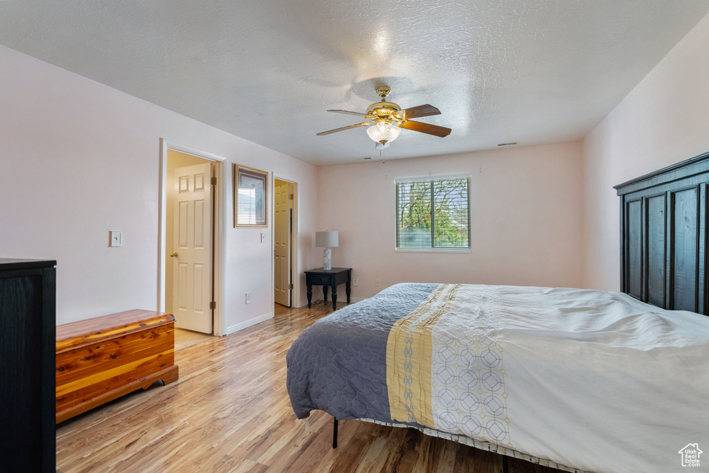 Bedroom with ceiling fan and light wood-type flooring