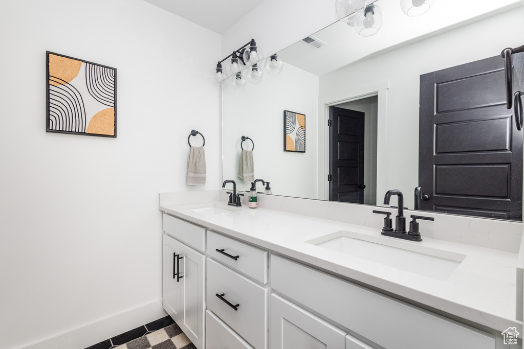 Bathroom featuring tile flooring, double sink, and large vanity