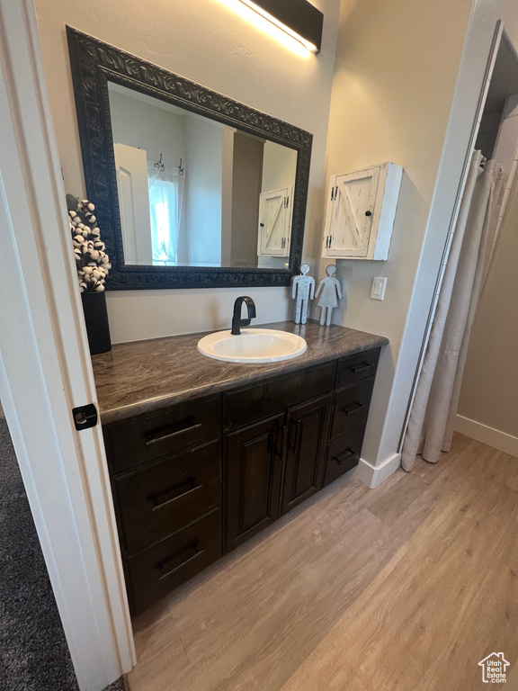 Bathroom with hardwood / wood-style flooring and vanity