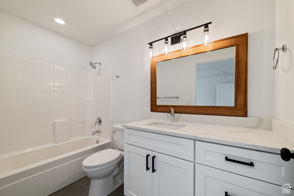 Full bathroom featuring tile flooring, shower / bathtub combination, large vanity, and toilet
