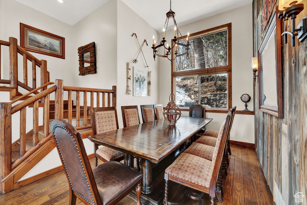 Dining room featuring dark hardwood / wood-style flooring and a chandelier