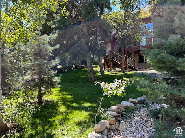 View of yard with a wooden deck