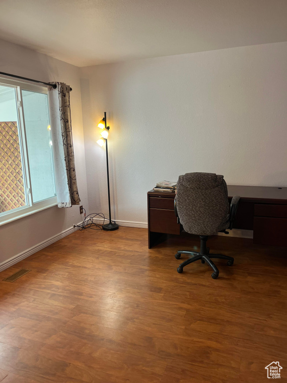 Home office featuring dark wood-type flooring