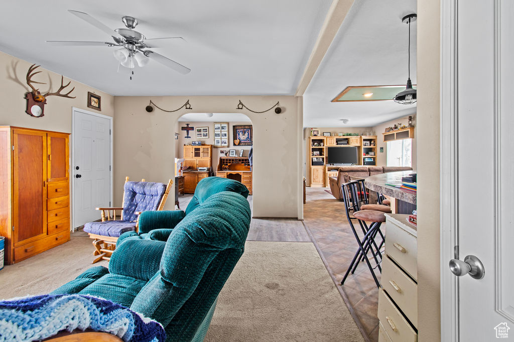 Living room with light colored carpet and ceiling fan
