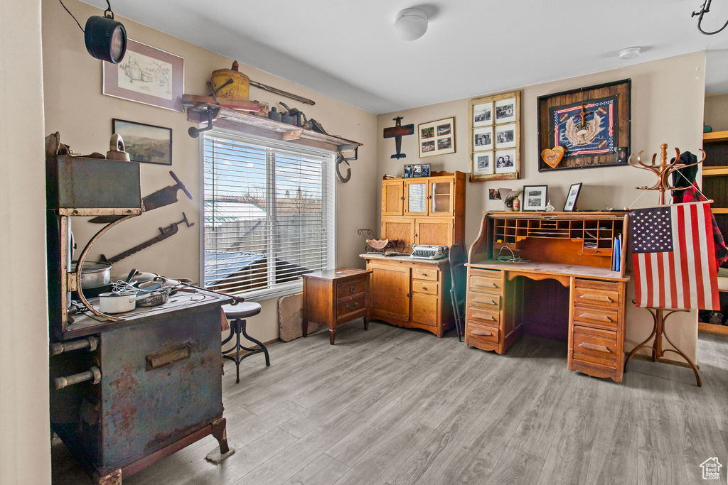 Home office with light hardwood / wood-style flooring