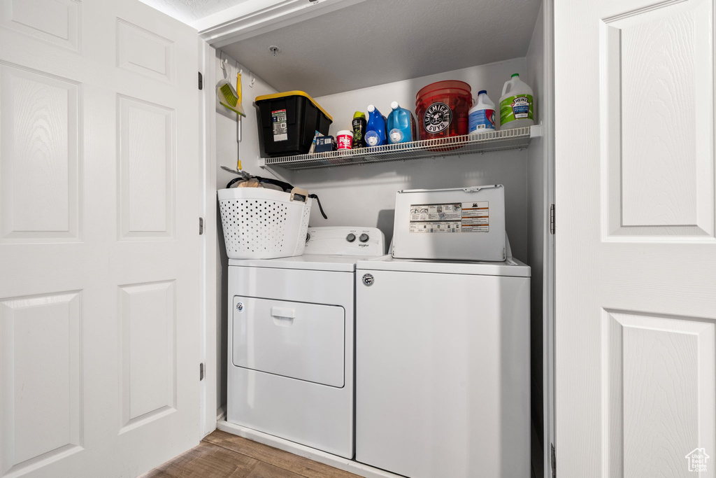 Laundry area featuring separate washer and dryer and dark hardwood / wood-style floors