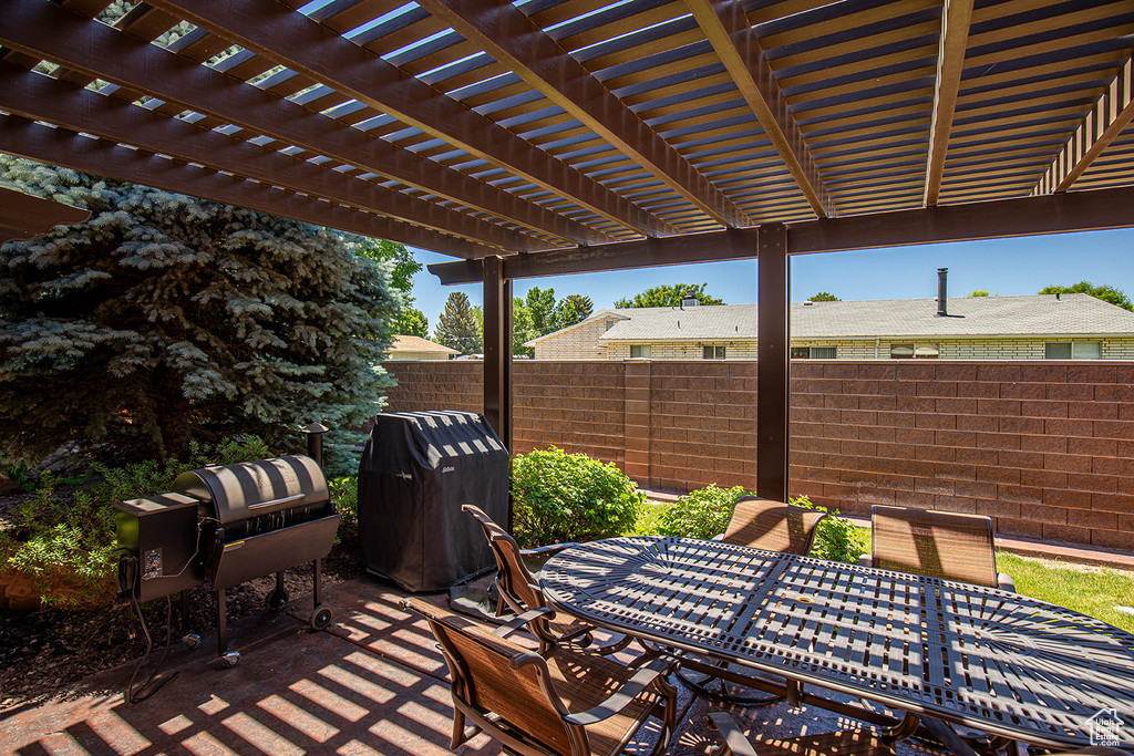 View of patio featuring a pergola and area for grilling