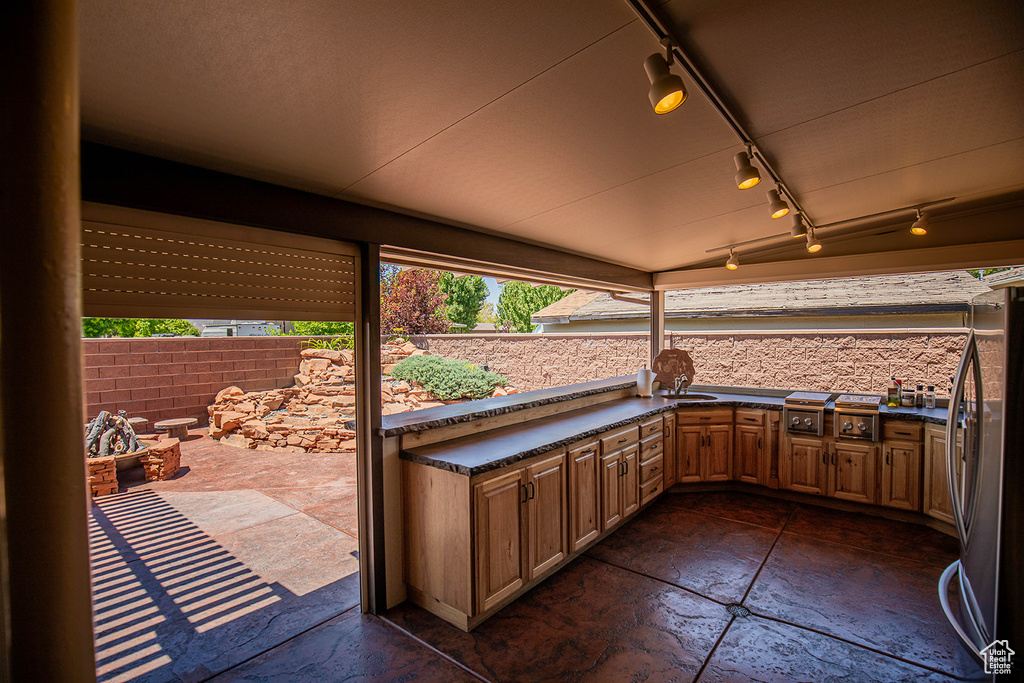 View of patio featuring sink and exterior kitchen
