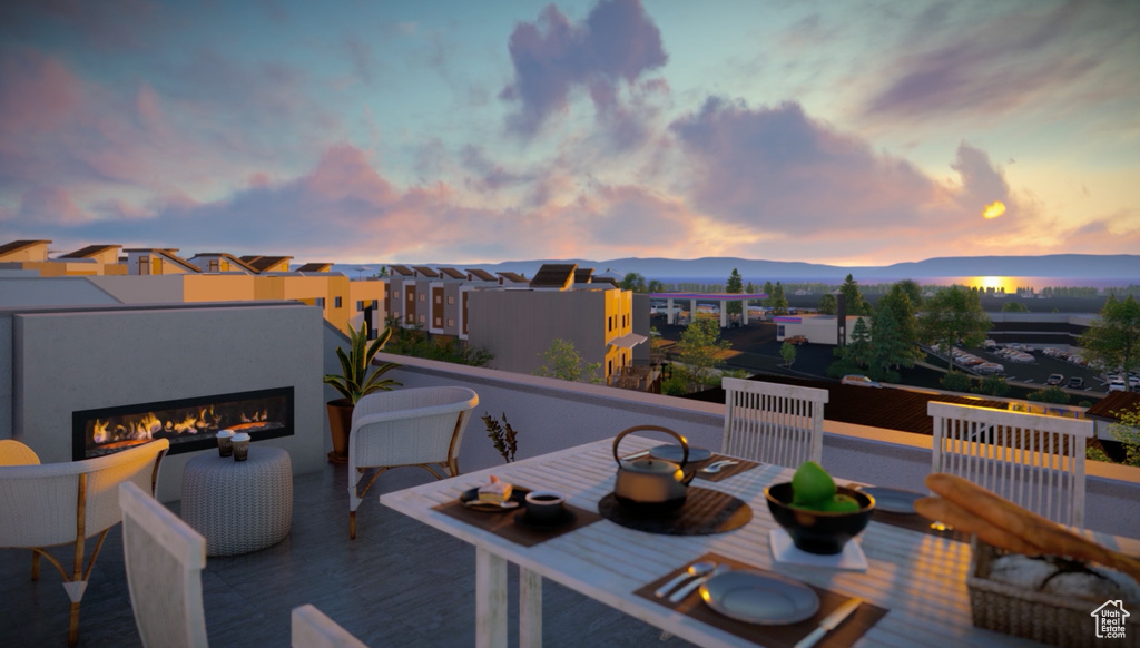 Patio terrace at dusk with an outdoor fireplace
