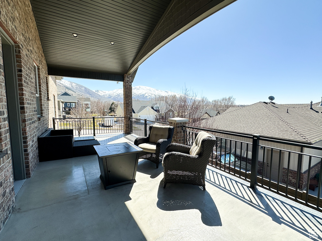 View of patio / terrace featuring an outdoor hangout area, a balcony, and a mountain view