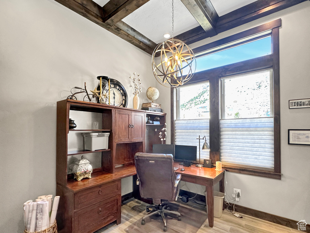 Office area with an inviting chandelier, beam ceiling, coffered ceiling, and light hardwood / wood-style floors