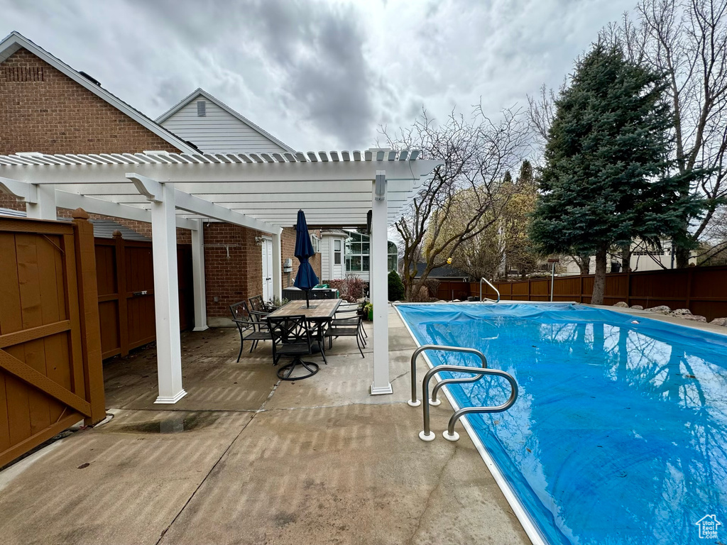 View of pool featuring a pergola and a patio