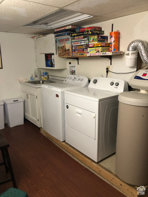 Laundry area with dark hardwood / wood-style floors, sink, hookup for a washing machine, and washer and dryer