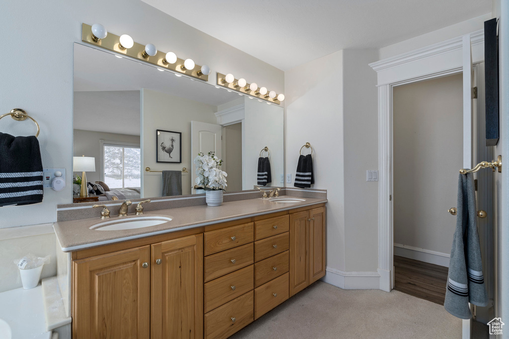 Bathroom featuring hardwood / wood-style floors, double sink, and oversized vanity