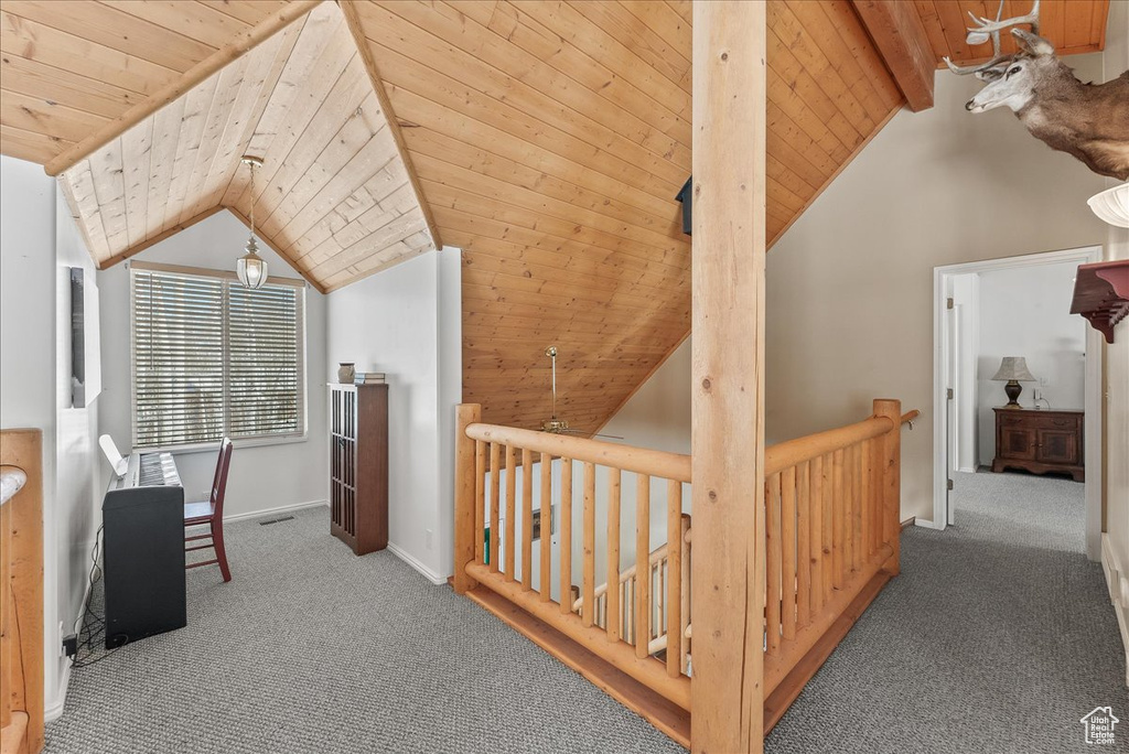 Bonus room featuring lofted ceiling with beams, light colored carpet, and wooden ceiling