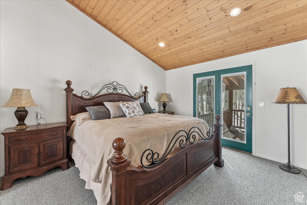 Carpeted bedroom with wood ceiling, vaulted ceiling, and access to exterior