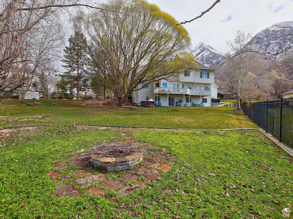 View of yard featuring an outdoor fire pit and a mountain view