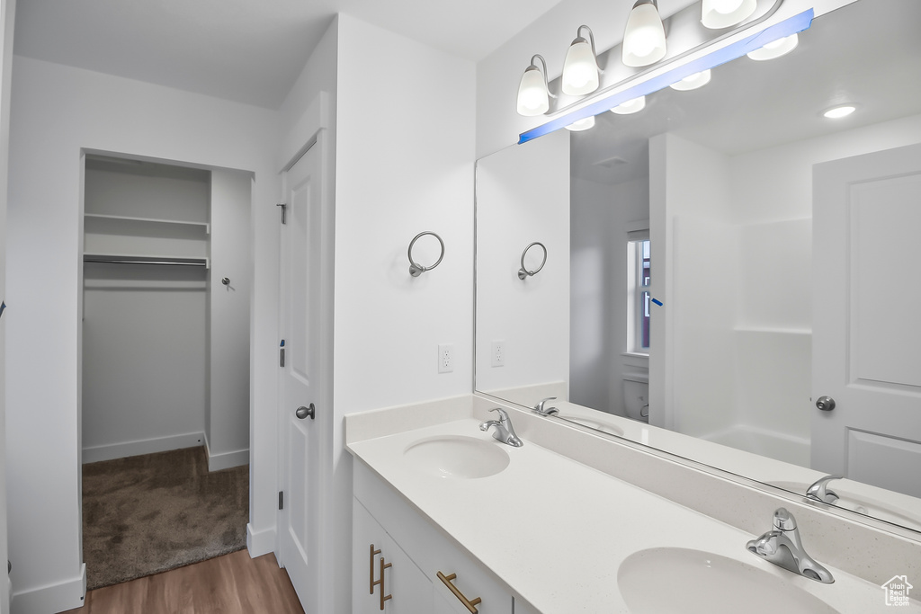 Bathroom with hardwood / wood-style floors and double vanity