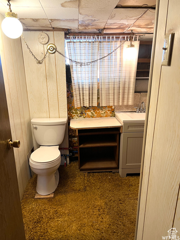 Bathroom with vanity, a paneled ceiling, and toilet