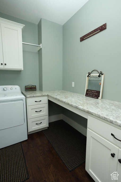 Laundry room featuring washer / clothes dryer, dark hardwood / wood-style floors, and cabinets