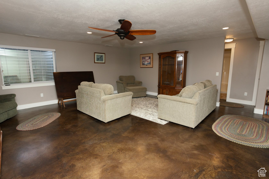 Living room with a textured ceiling and ceiling fan