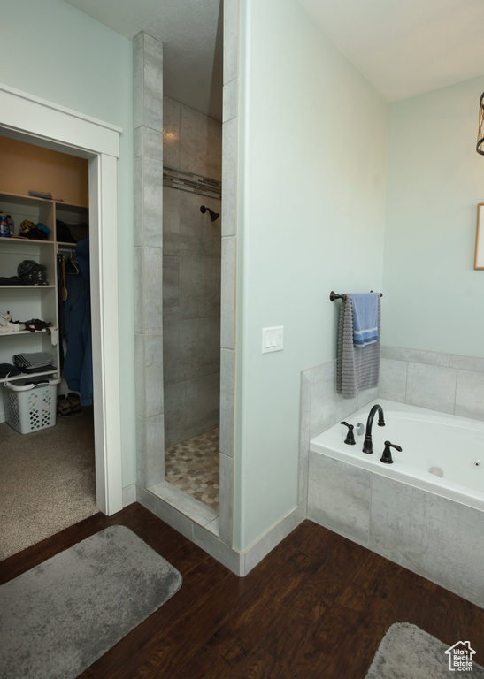 Bathroom with hardwood / wood-style floors and plus walk in shower
