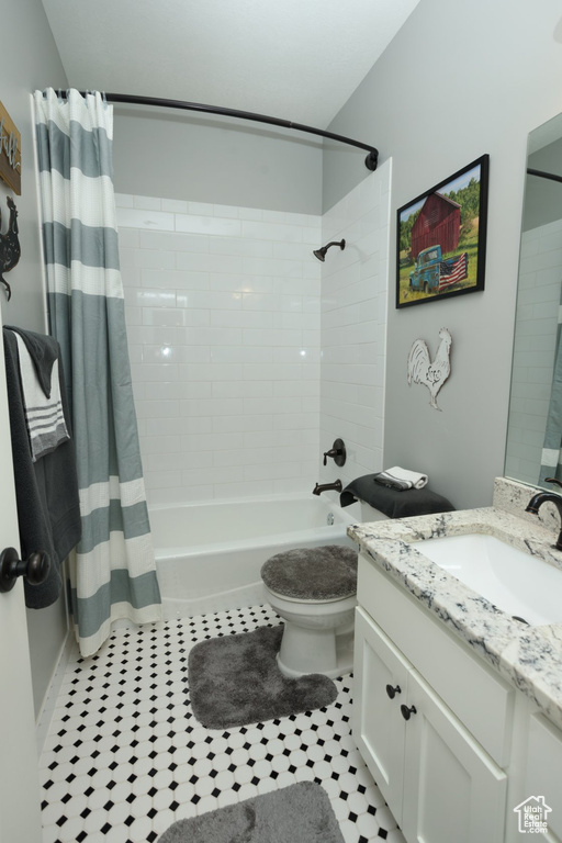 Full bathroom featuring toilet, shower / bath combo, tile floors, and oversized vanity