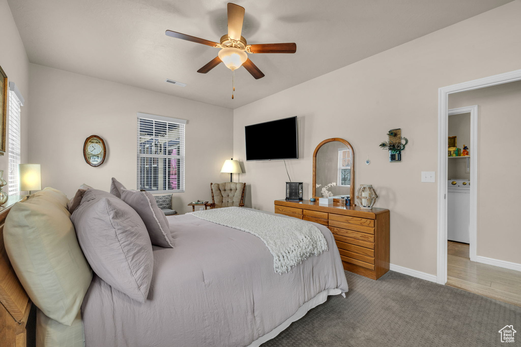 Carpeted bedroom featuring washer / dryer and ceiling fan
