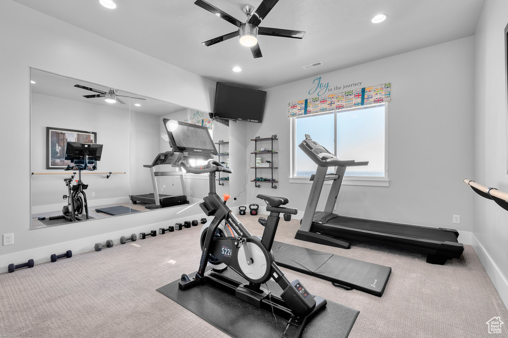 Exercise area featuring ceiling fan and carpet floors