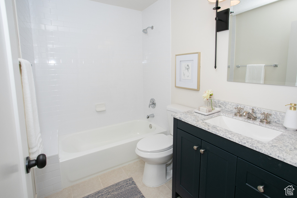 Full bathroom with tile flooring, vanity, washtub / shower combination, and toilet